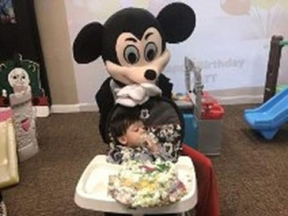 Mickey Mouse character with a child
